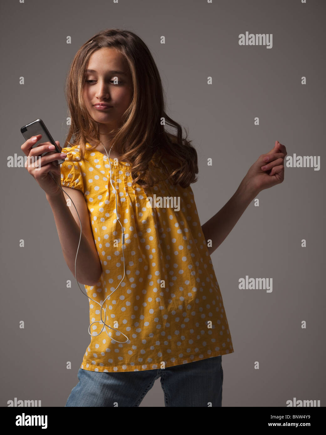 Teenage girl listening to music on I pod Stock Photo