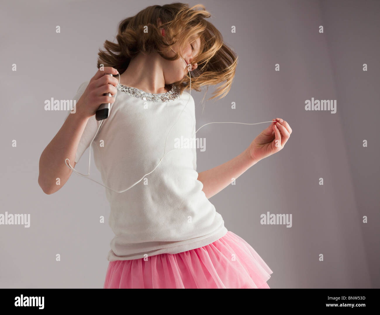 Young girl dancing on her bed Stock Photo