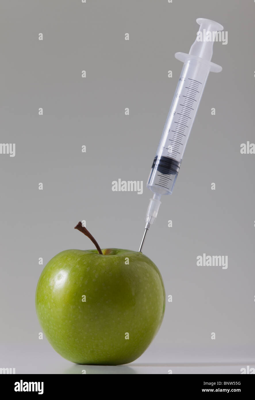 Syringe in apple Stock Photo
