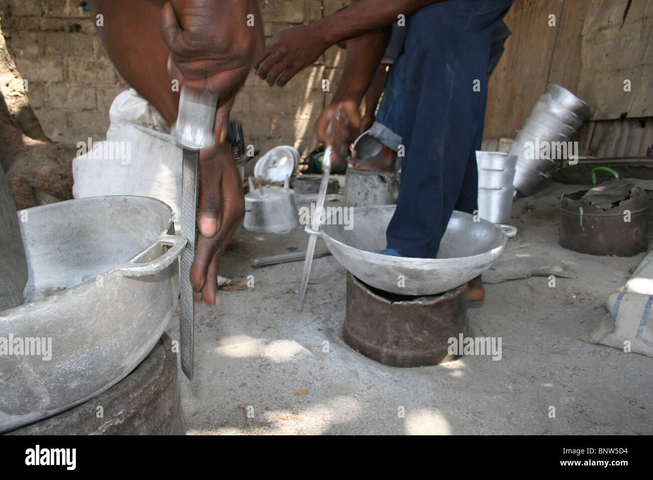 Filing down aluminium pots made from reclaimed metal, The Gambia, 2008 Stock Photo