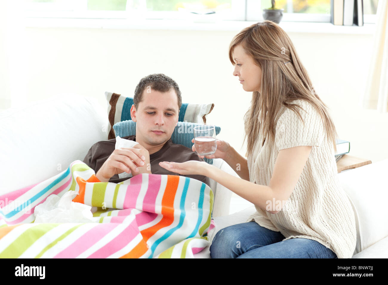 Positive woman taking care of her husband Stock Photo