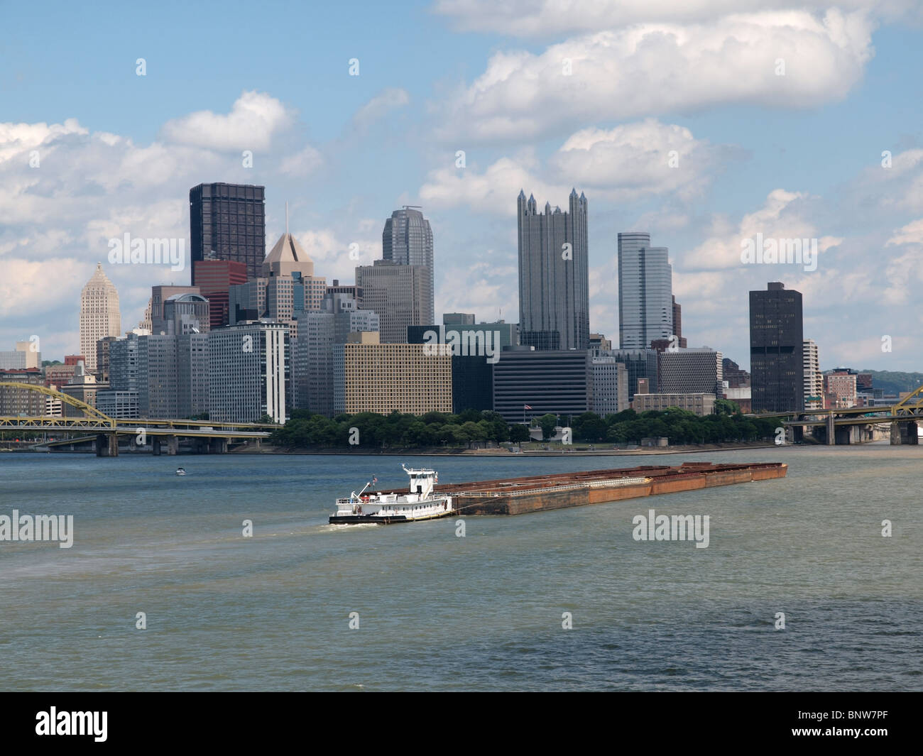 Pittsburgh riverfront with large barge in motion. Stock Photo