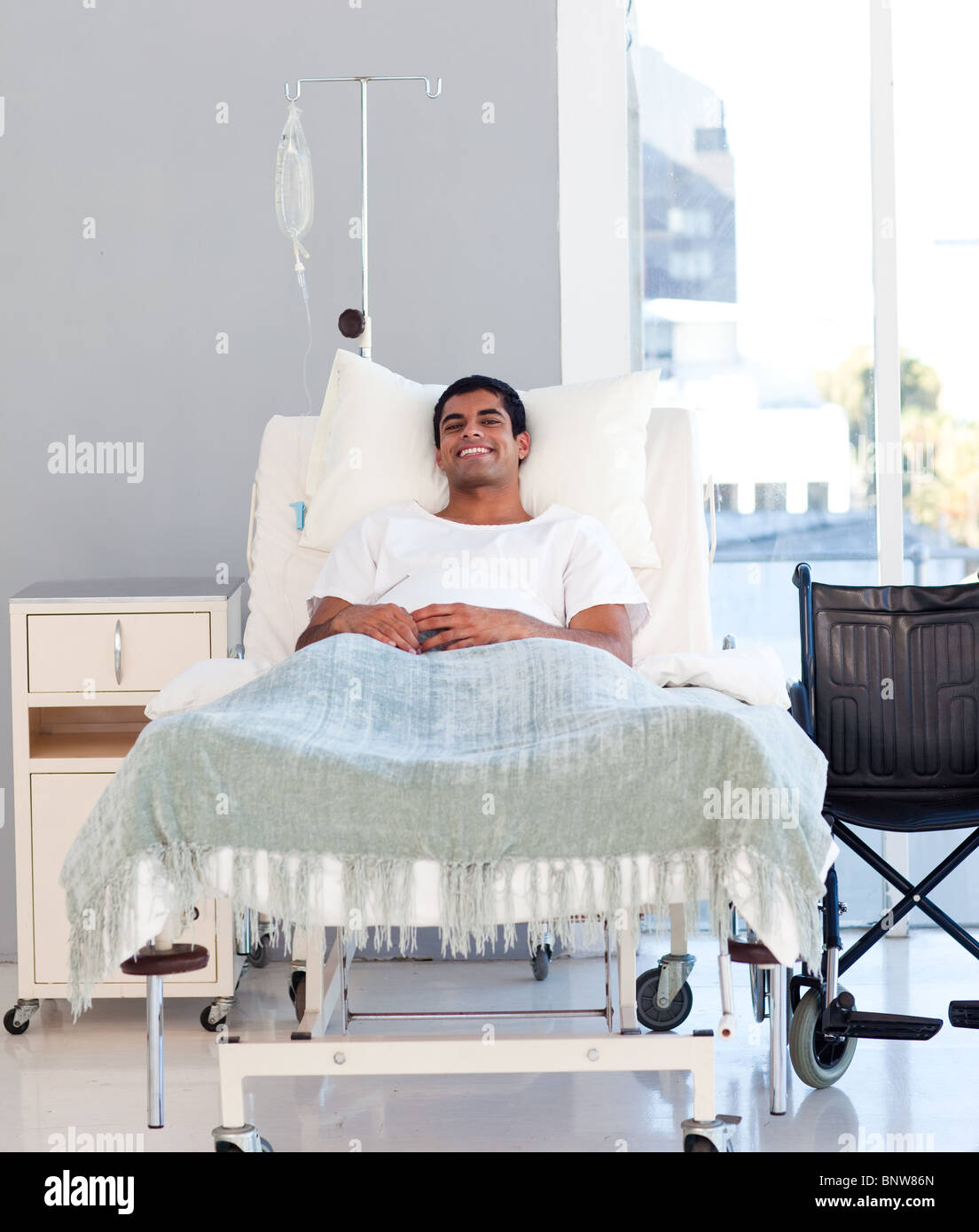 Young patient recovering in bed Stock Photo