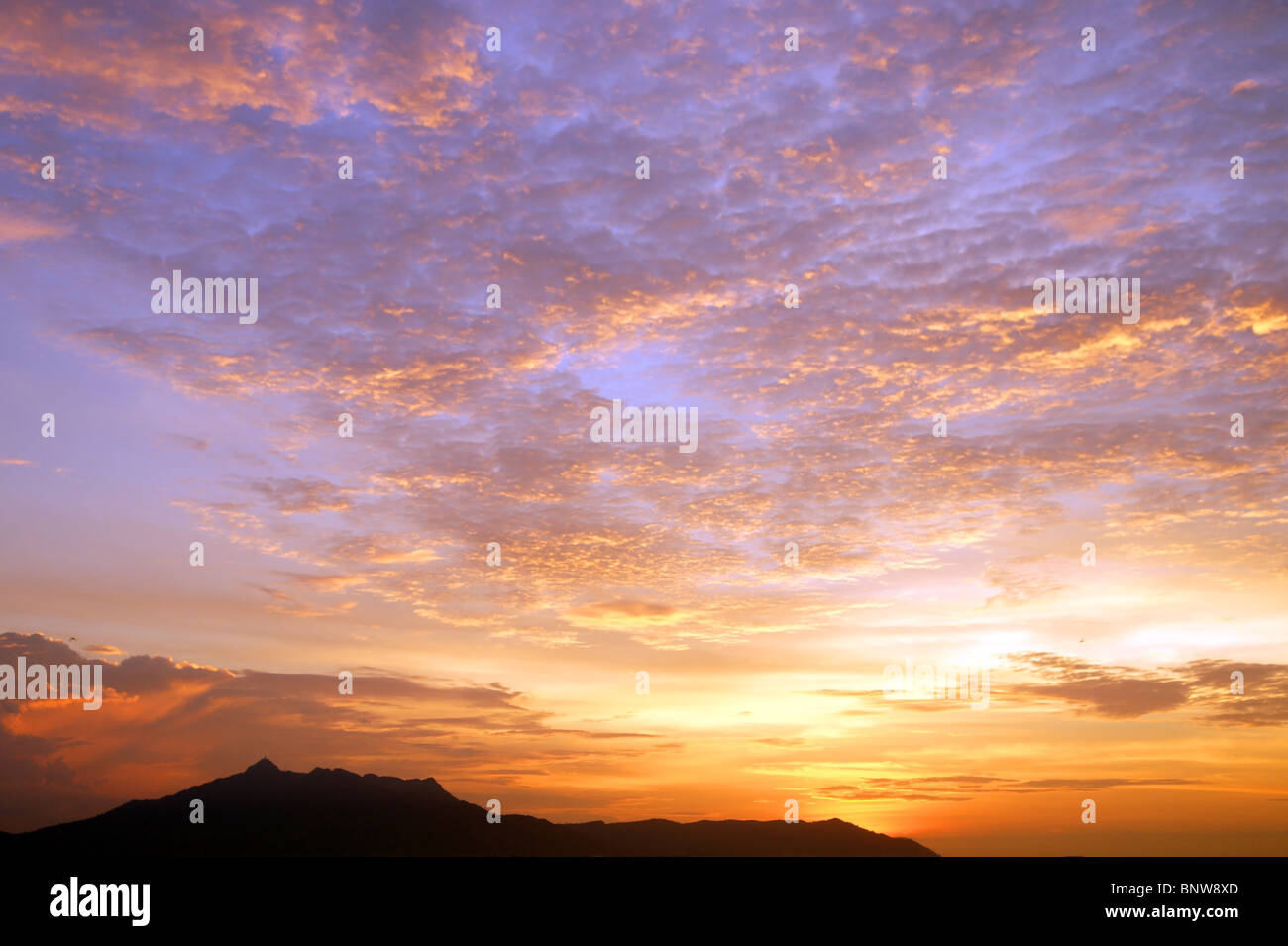 Sunset with a kind on mountains Matang from height of the bird's flight. Malaysia. Borneo. Kuching. Stock Photo