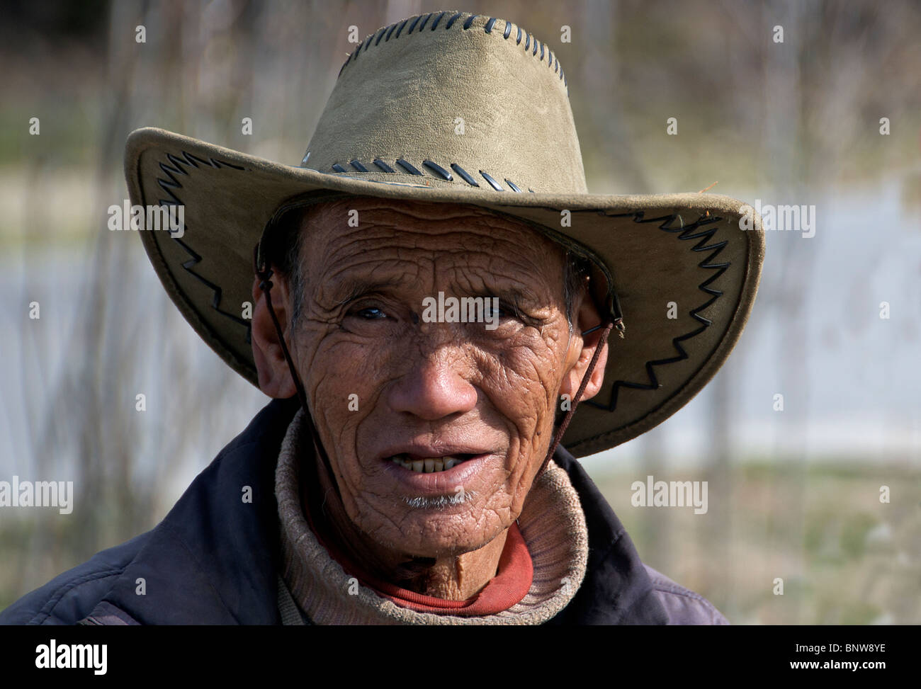Portrait old farmer Emerald Lake Yunnan China Stock Photo