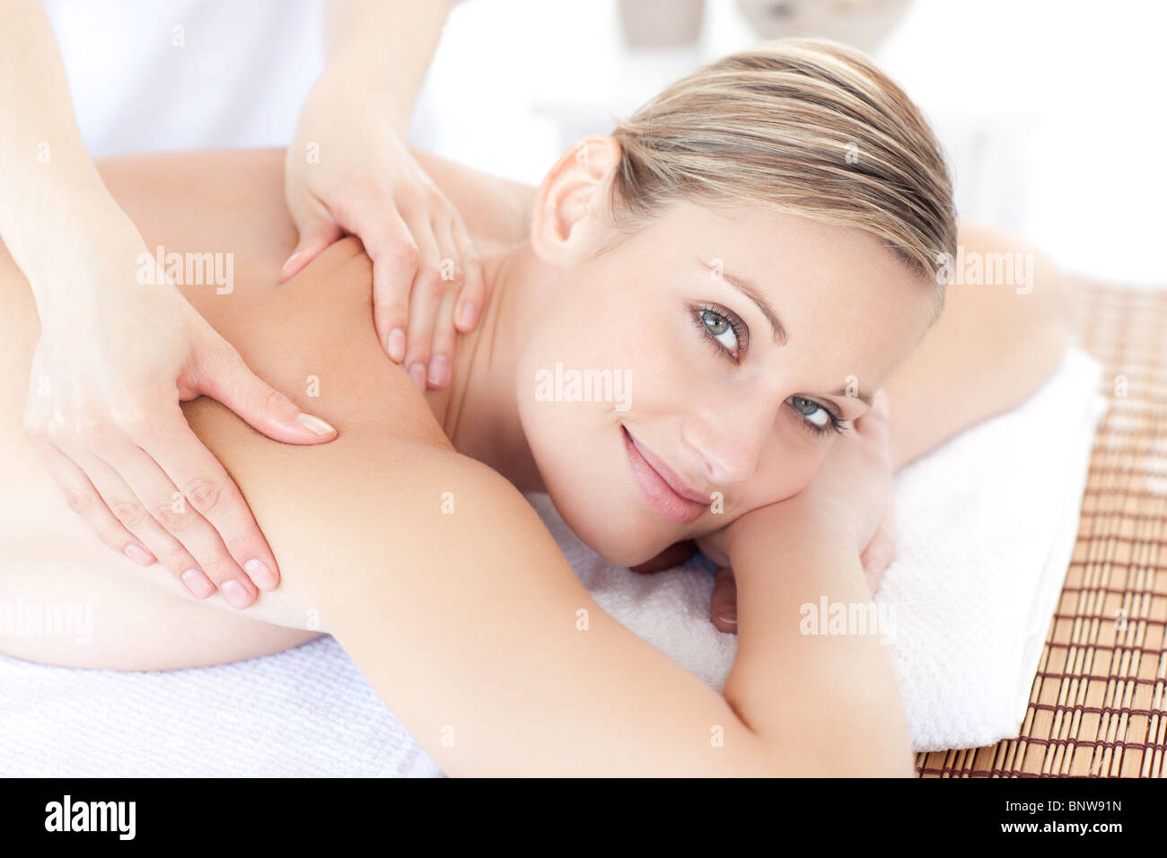 Smiling woman receiving a back massage Stock Photo