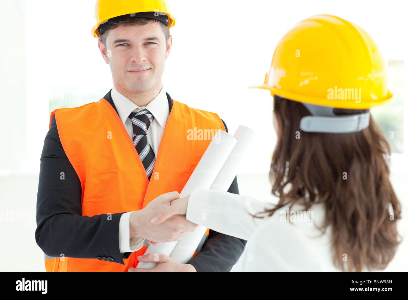 Mature architect discussing with his colleague Stock Photo