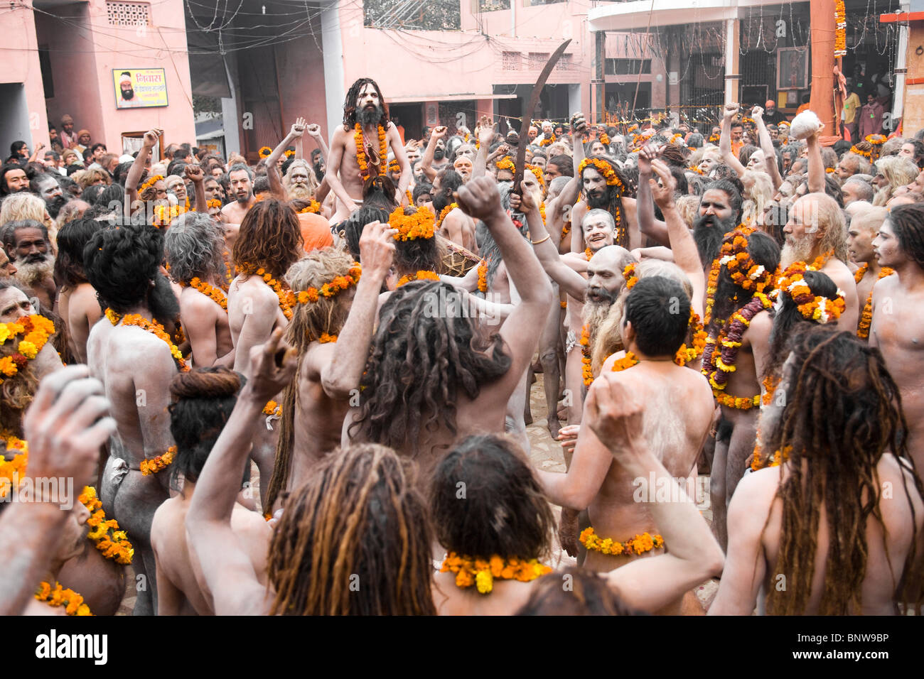 A crowd of Naga sadhus walk along the streets during the Kumbh mela Stock Photo