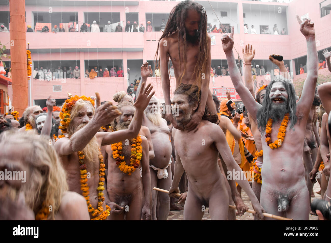 A crowd of Naga sadhus walk along the streets during the Kumbh mela Stock Photo