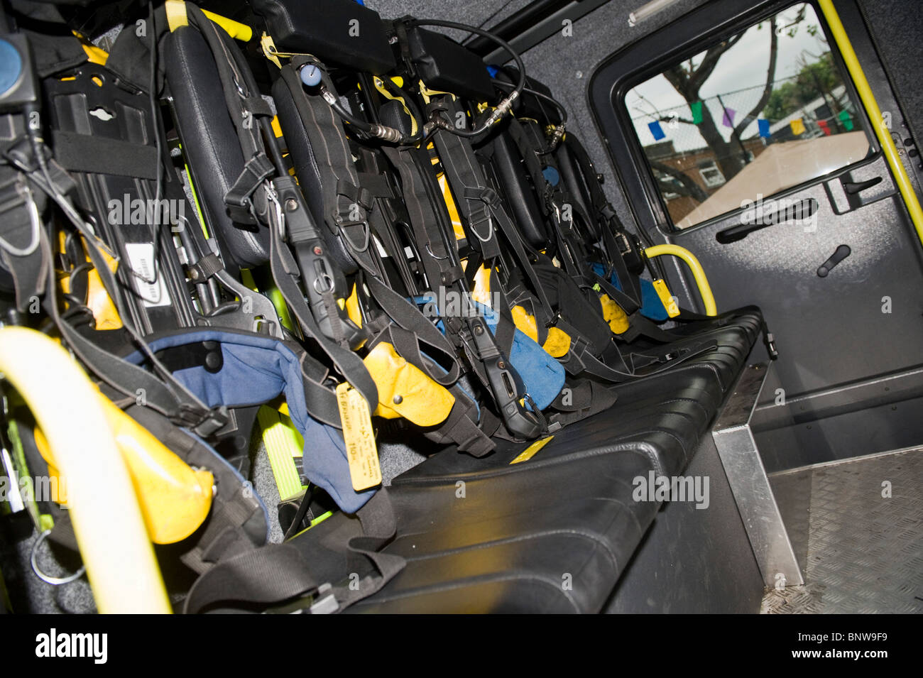 Members of the London Fire Service, some in breathing apparatus, go
