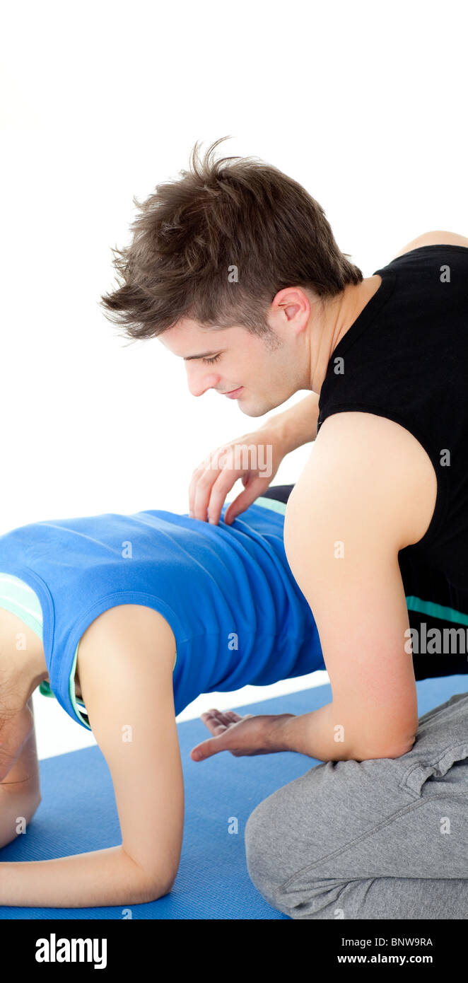 Woman working out assited by her personal trainer Stock Photo