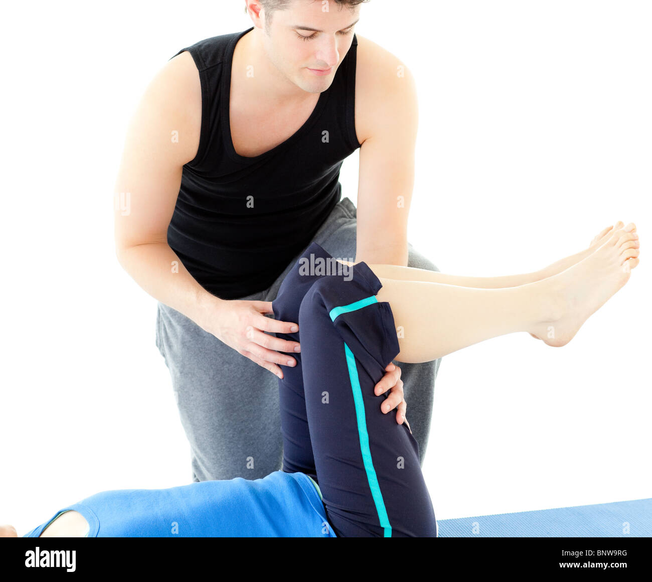 Woman exercising assited by her personal trainer Stock Photo