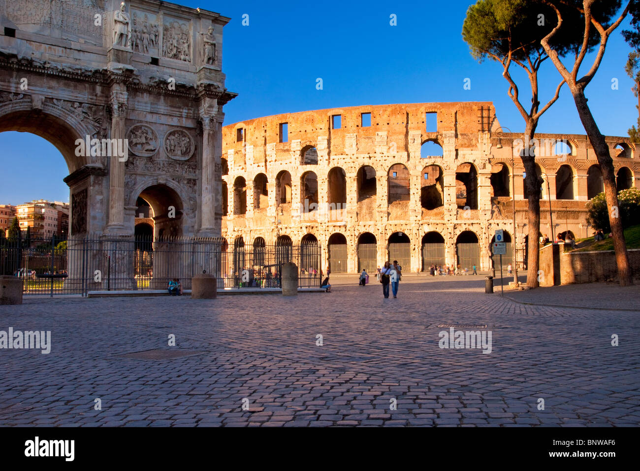Couple walking the cobblestones near the Roman Coliseum, Rome Lazio Italy Stock Photo