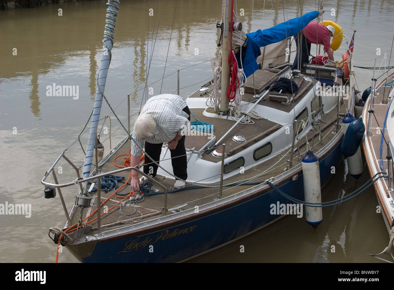 tied double berthed sailing boat sailors talking Stock Photo