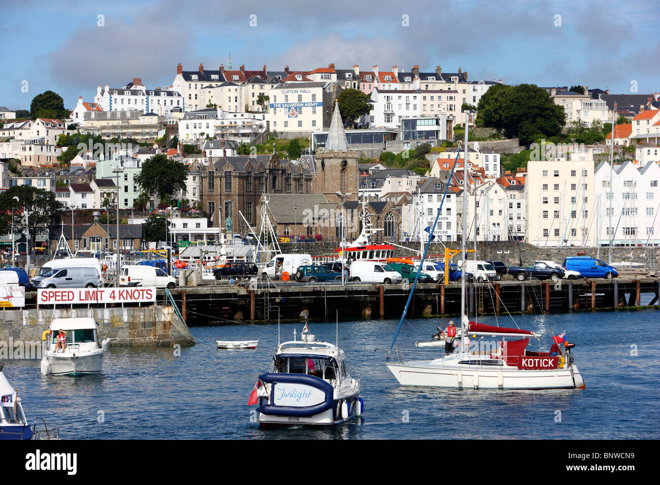 Harbor, port of St. Peter Port, Guernsey, UK, Channel islands. Sailing boats and yachts in the harbor basin, skyline of the city Stock Photo