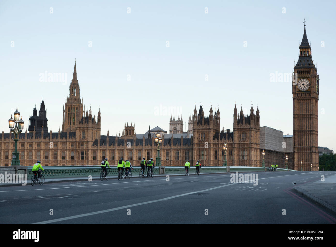 Cyclists in reflective vests ride by the Palace of Westminster on the London Night Ride, London, United Kingdom Stock Photo