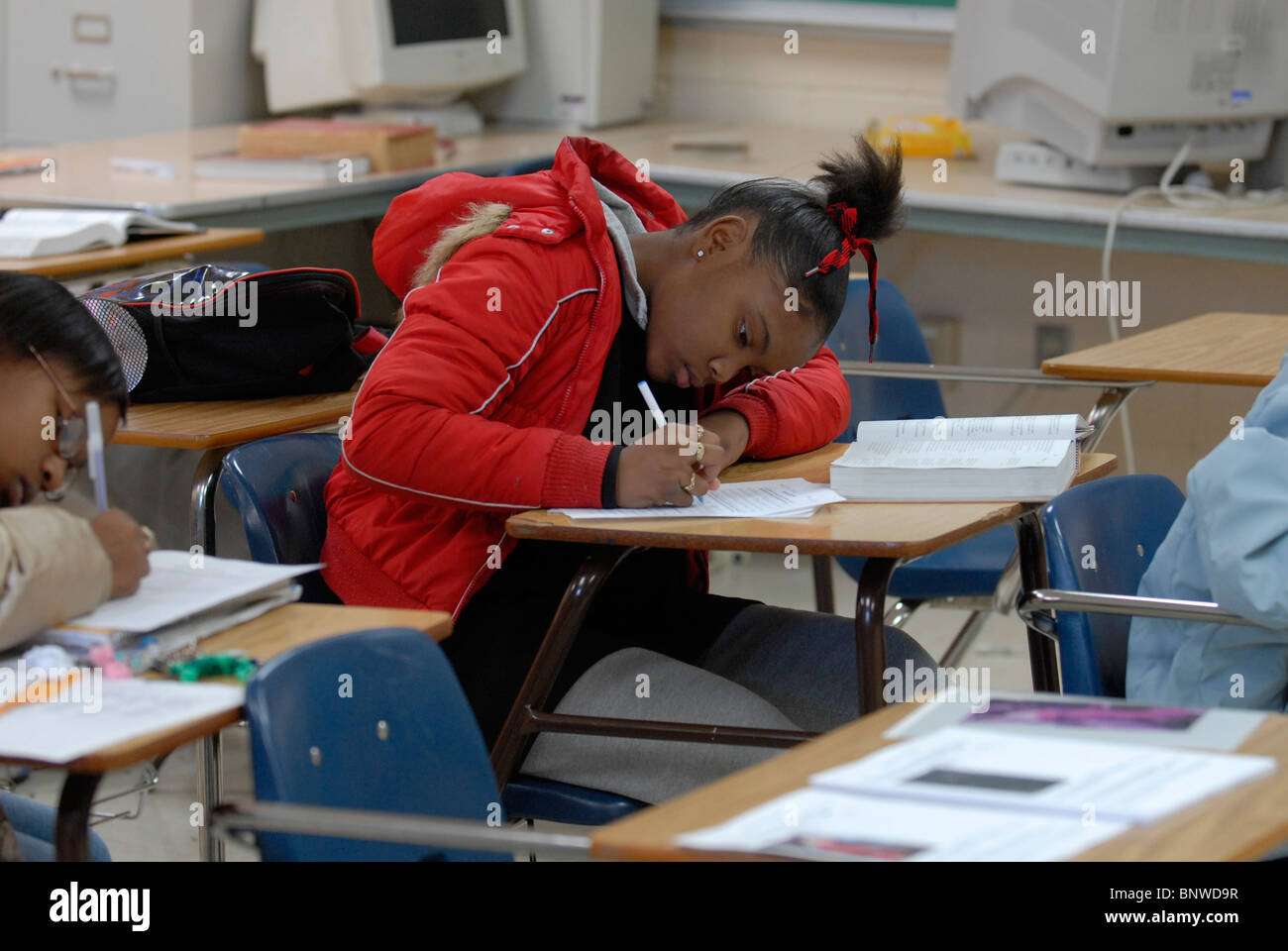 African-American boy in 21th-grade English class works on writing