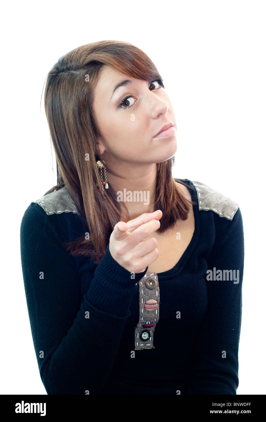 High key image against a white background of a pretty, 16 year old girl pointing her finger with authority and warning. Concepts. Stock Photo
