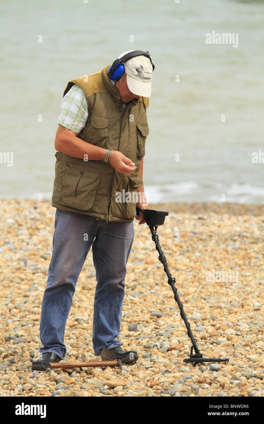 A man searches for buried treasure using a metal detector on Eastbourne