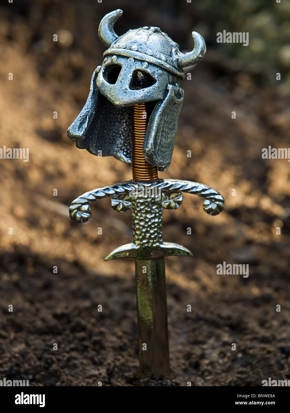 Type of a warrior's grave with a sword and helmet instead of cross. Stock Photo