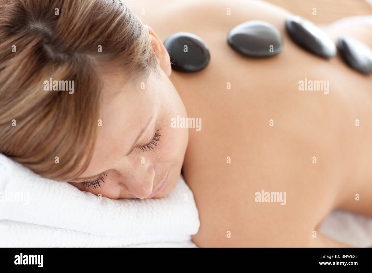 Close-up of a bright woman having a stone therapy Stock Photo