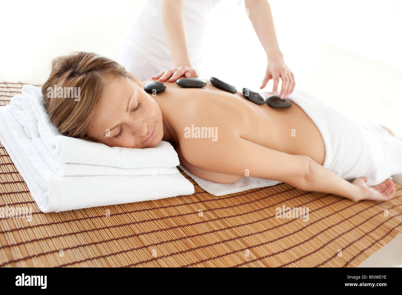 Delighted woman lying on a massage table Stock Photo