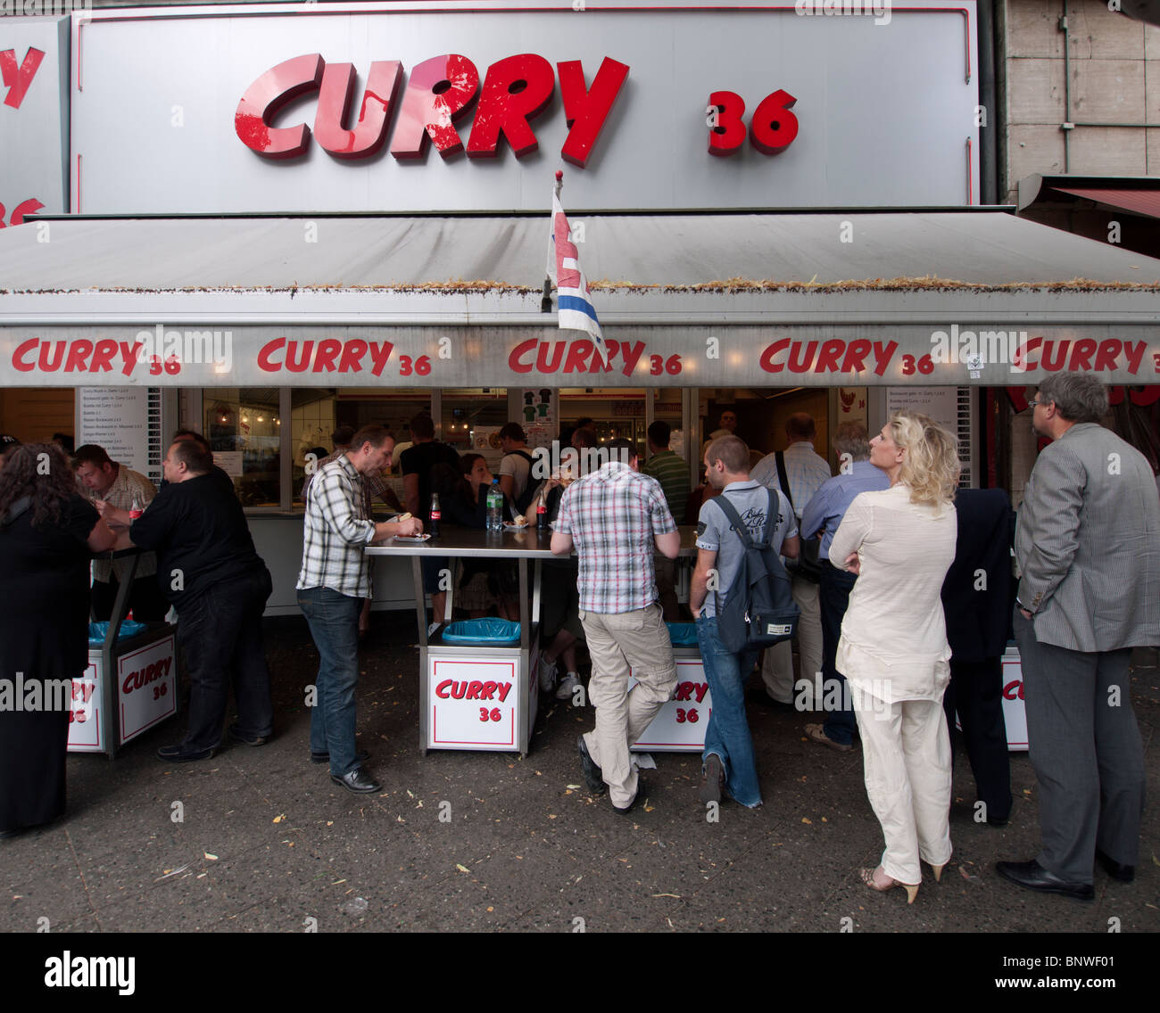 Many people eating at popular currywurst shop called Curry36 in Kreuzberg Berlin GErmany Stock Photo
