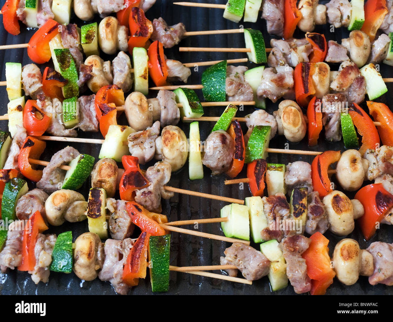 Grill sticks with meat and vegetables on fire Stock Photo Alamy