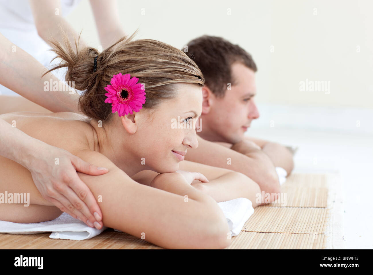 Jolly young couple receiving a back massage Stock Photo
