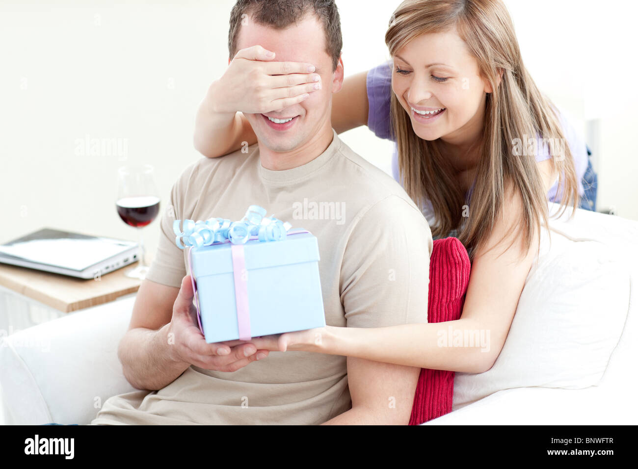 Present Partner Smiling woman giving a present to her boyfriend Stock Photo - Alamy
