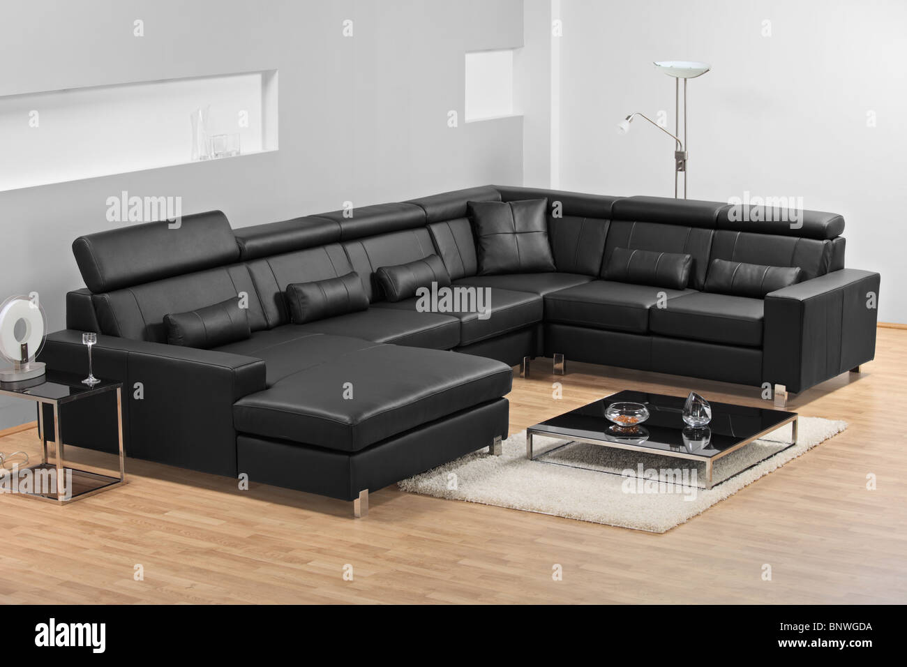 A view of a modern apartment with black leather sofa Stock Photo