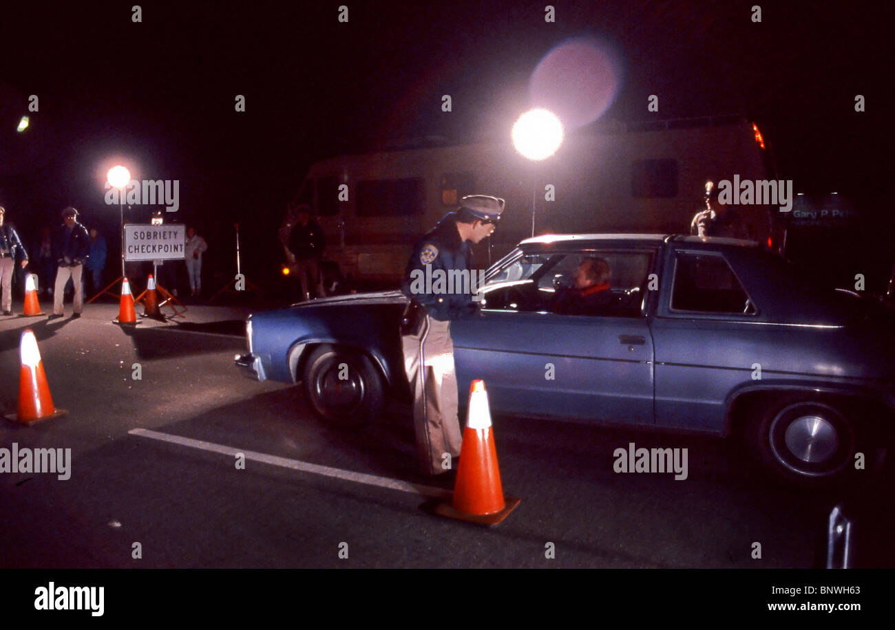 Checking for intoxicated drivers, police man a nightime 'Sobriety Checkpoint' on a California freeway. Stock Photo