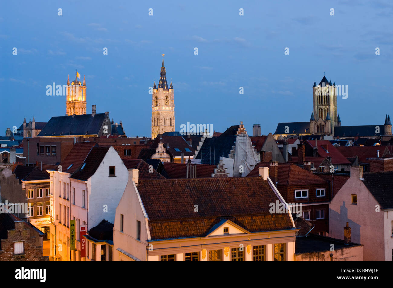 Belgium, Ghent, St Bavos Cathedral and Belfry of Ghent and red tiled roofs at dusk, Sint Baafskathedraal Stock Photo