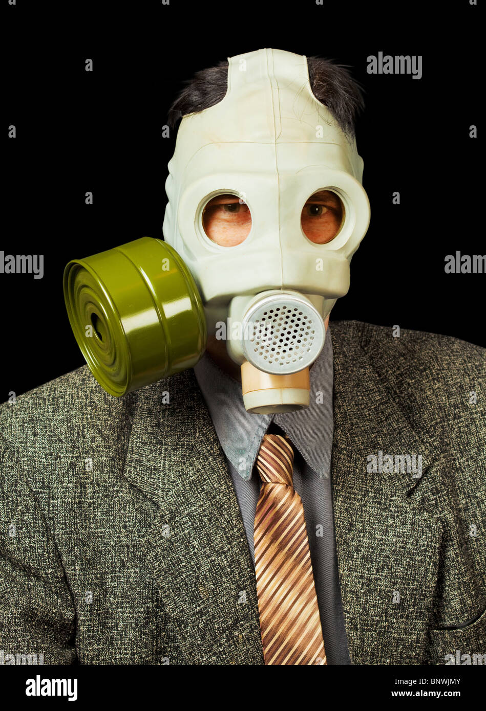 Portrait of the person in a gas mask on a black background Stock Photo