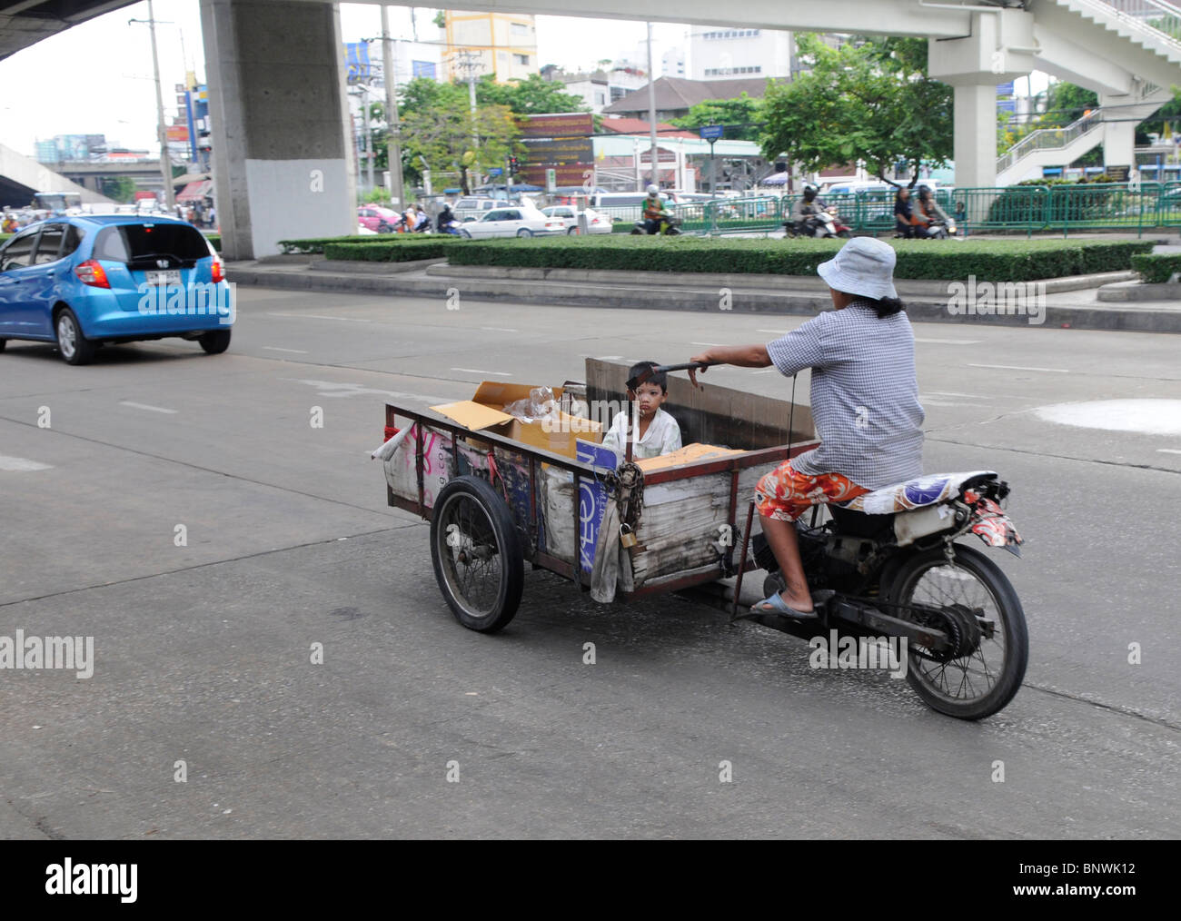 thai lady delivering goods on a weird thai invented three wheel motorbike , bangkok , thailand Stock Photo