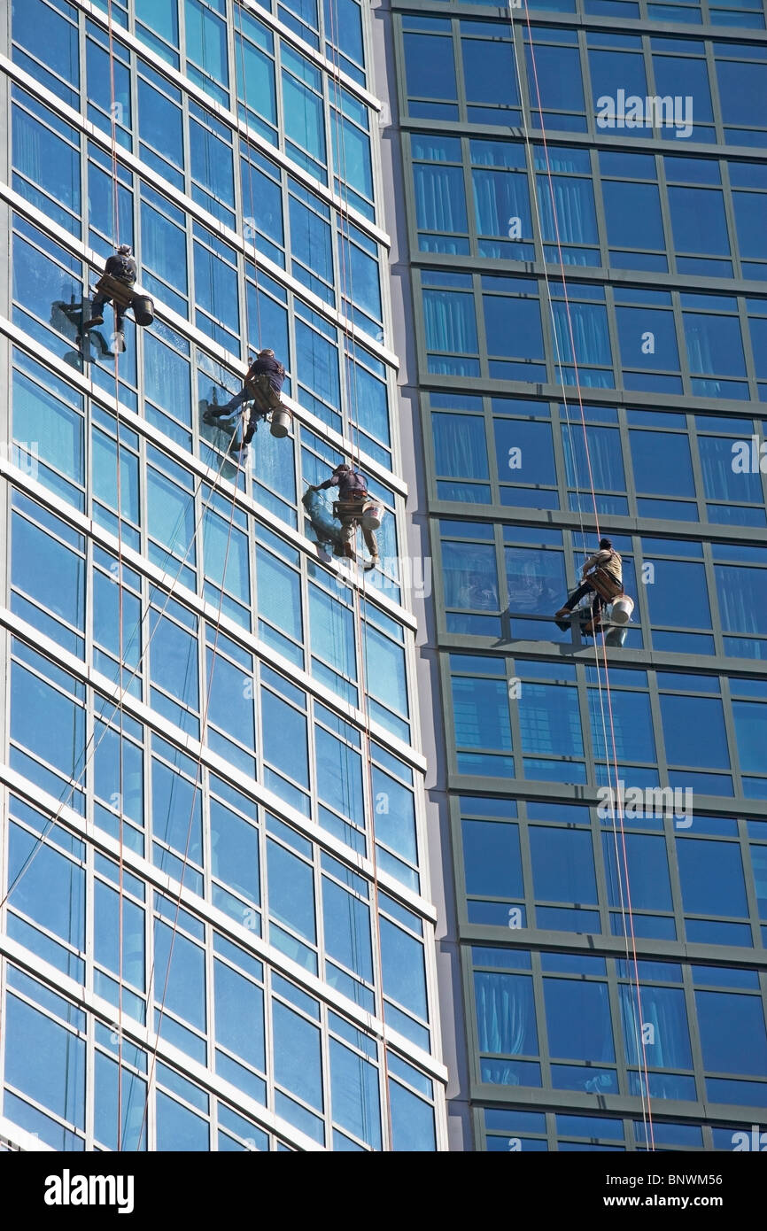 Window washers cleaning windows on skyscraper Stock Photo
