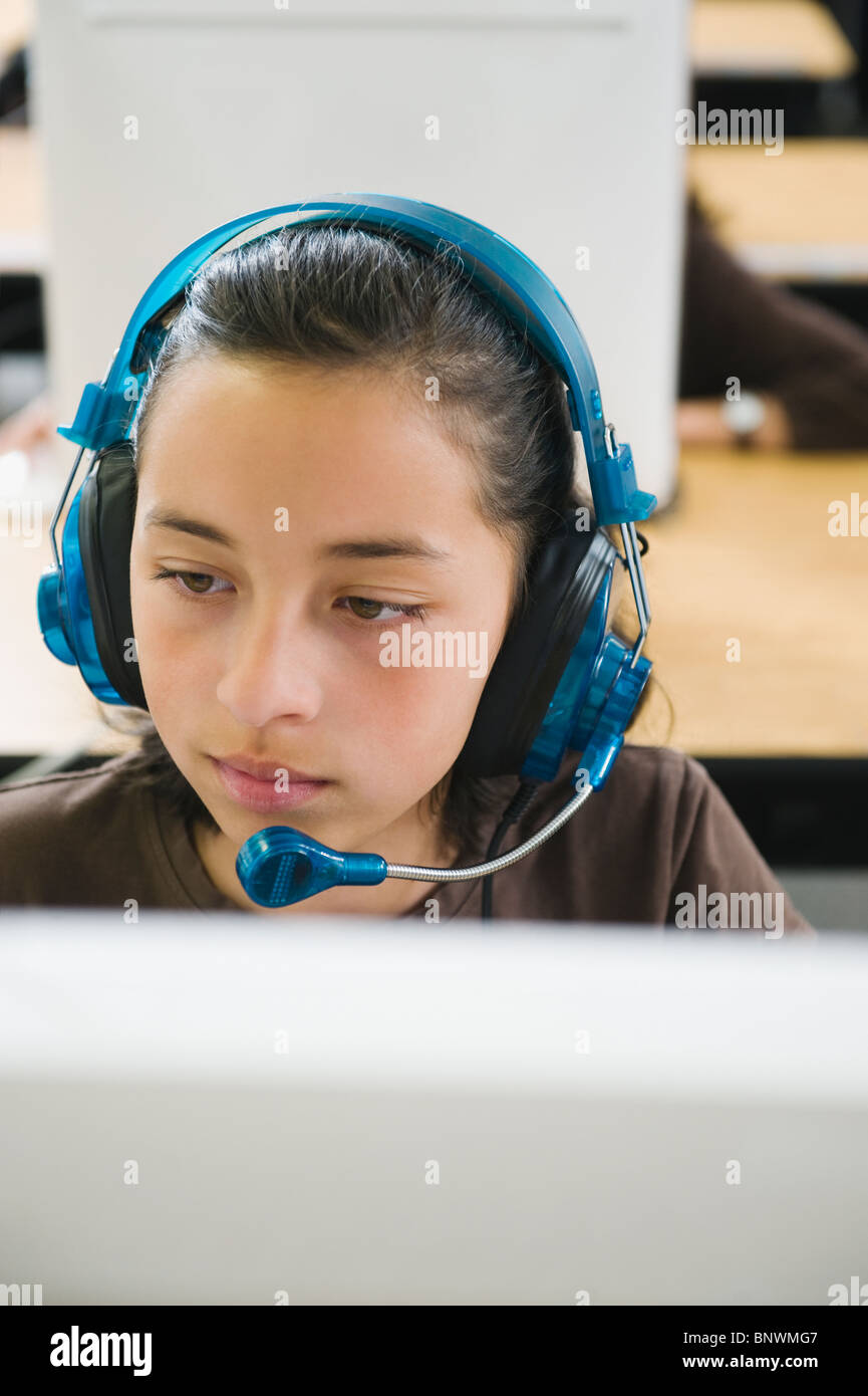 Elementary student wearing headphones in classroom Stock Photo Alamy