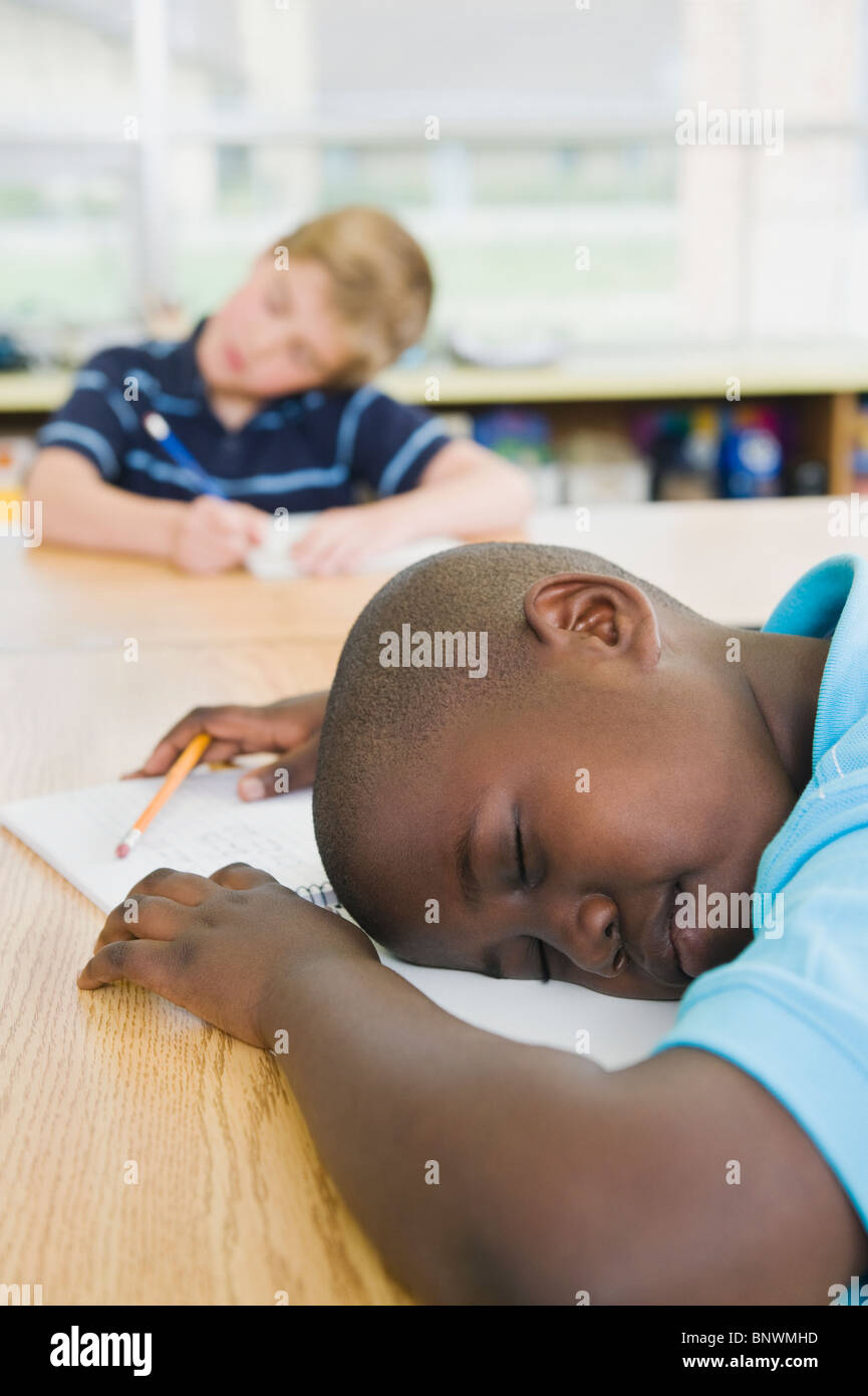 Elementary students sleeping at his desk Stock Photo Alamy