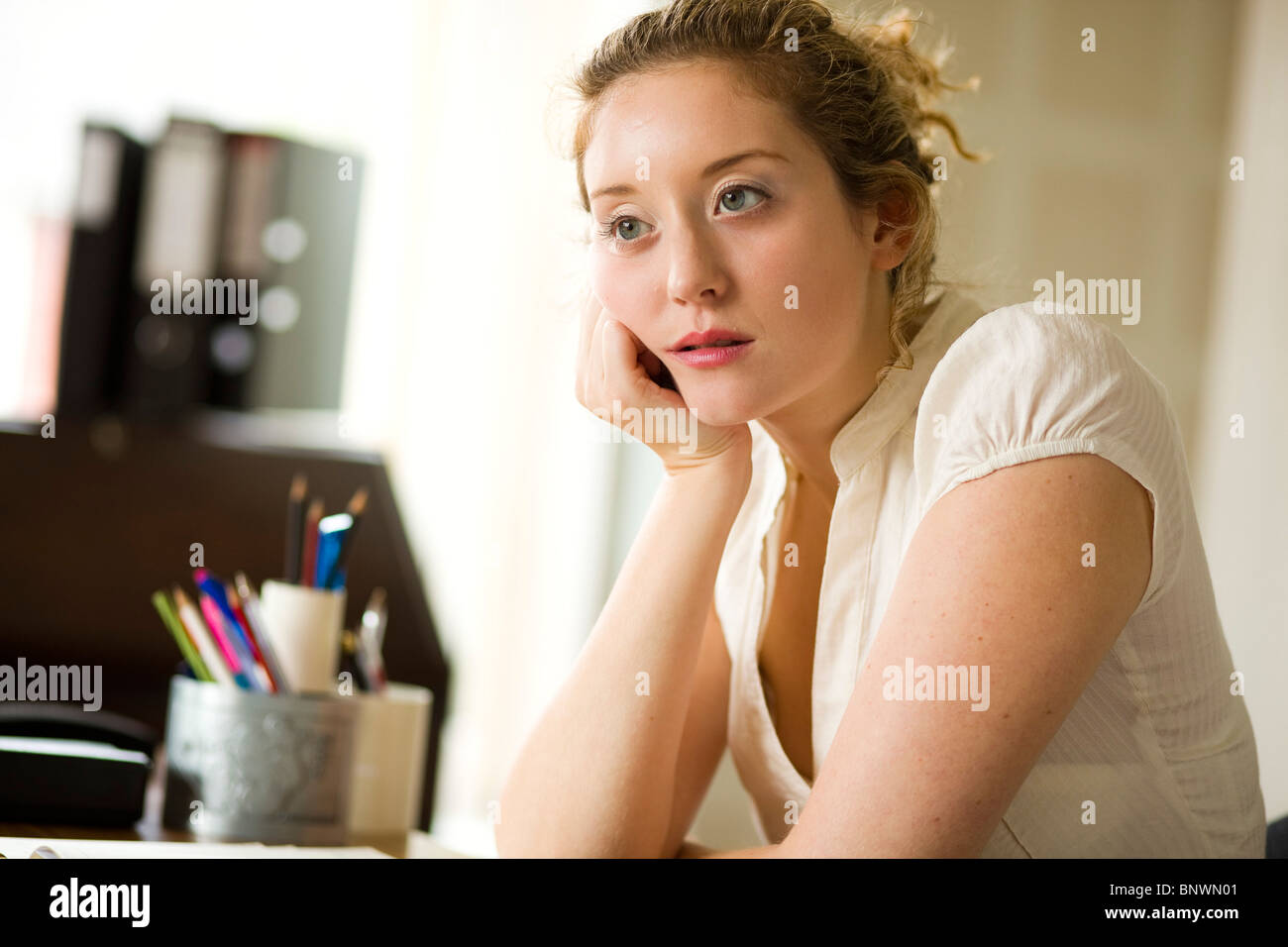 Woman in office bored Stock Photo