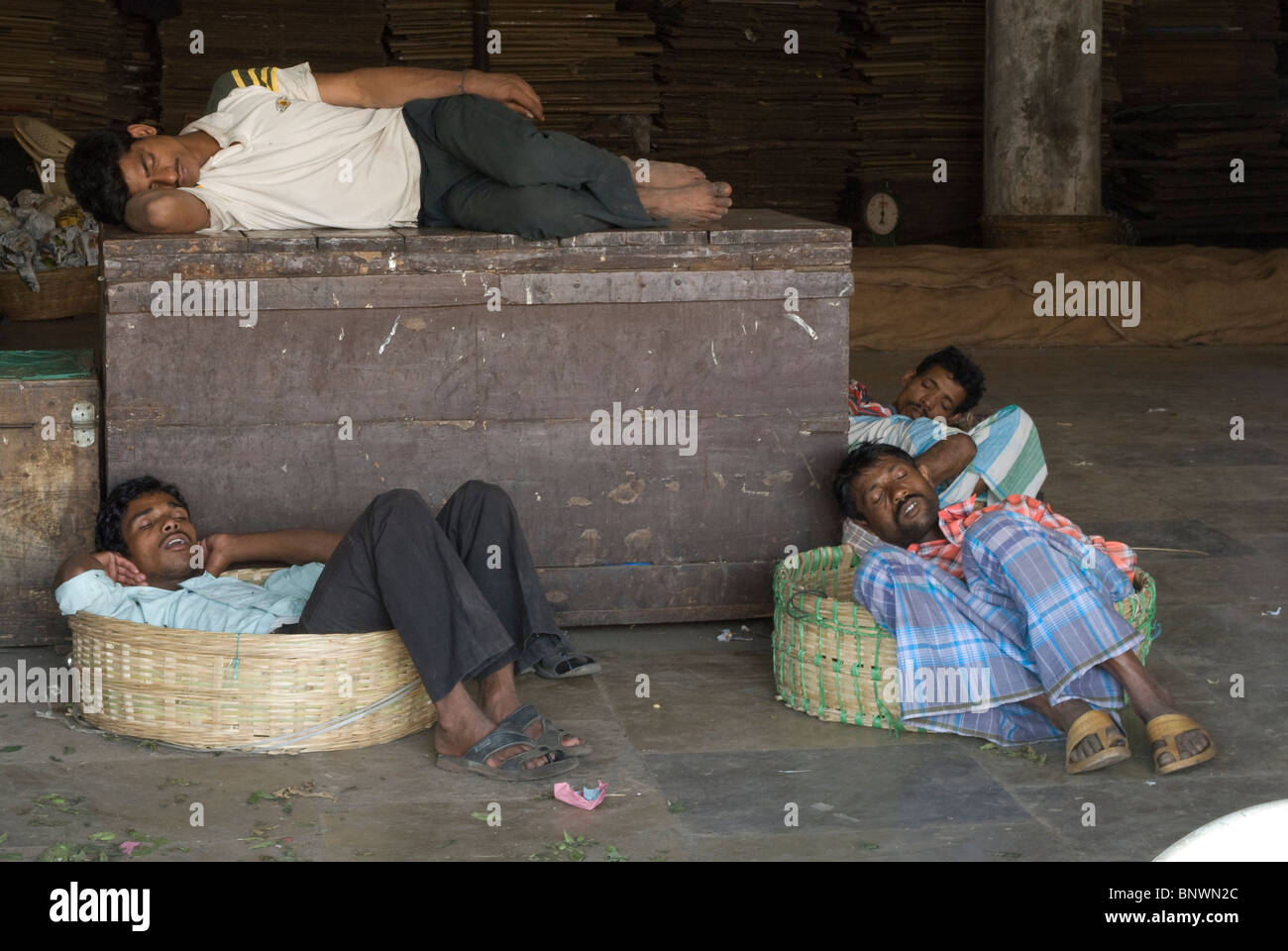 Tired Indian Laborers sleeping in Crawford market, Mumbai Stock Photo