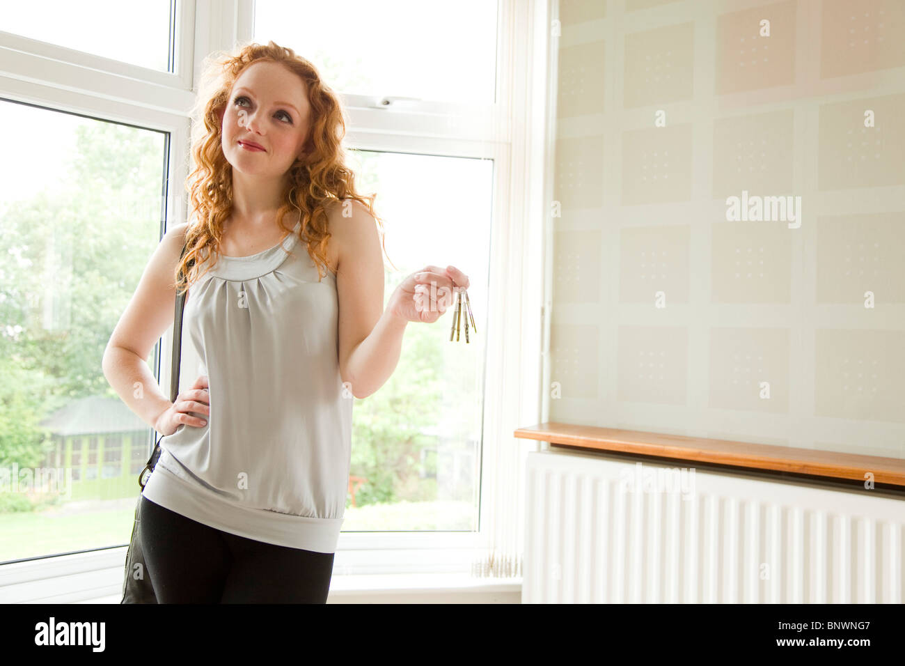 Woman holding keys to new property Stock Photo - Alamy