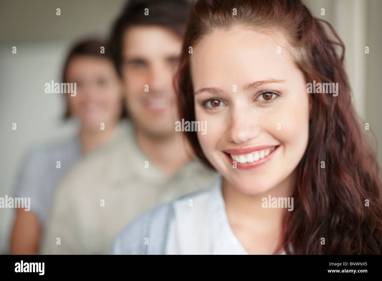 three people standing in a row Stock Photo - Alamy