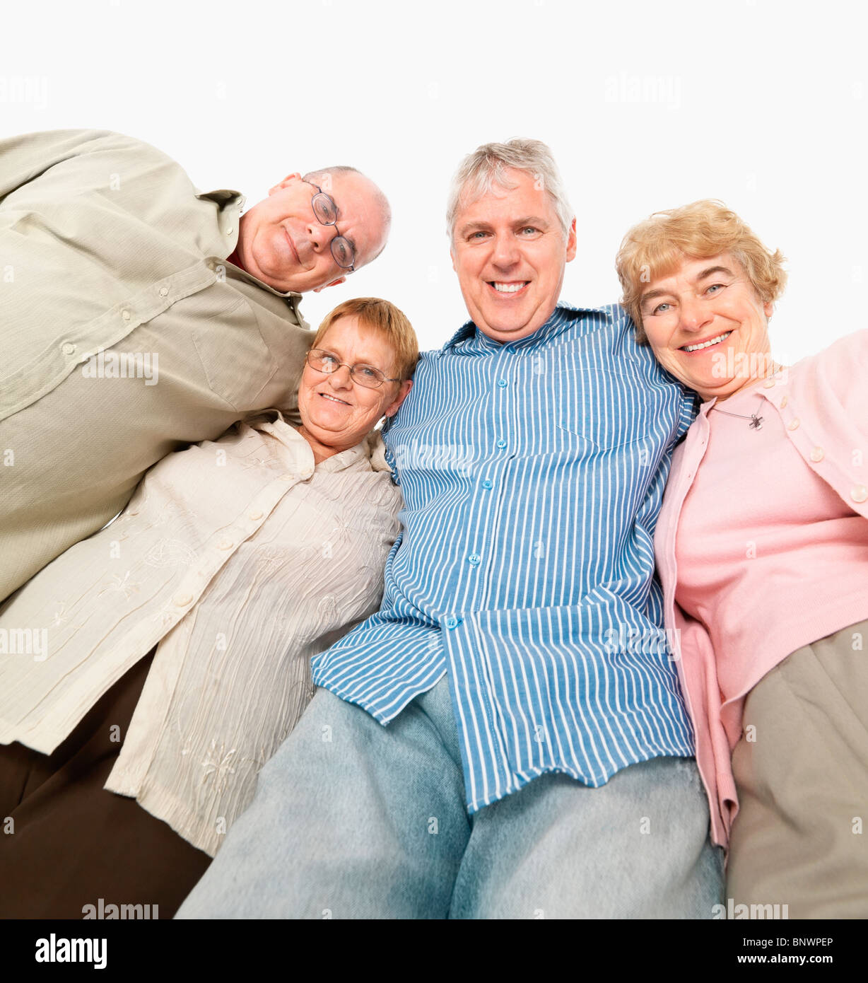 Four friends standing with their arms around each other Stock Photo - Alamy
