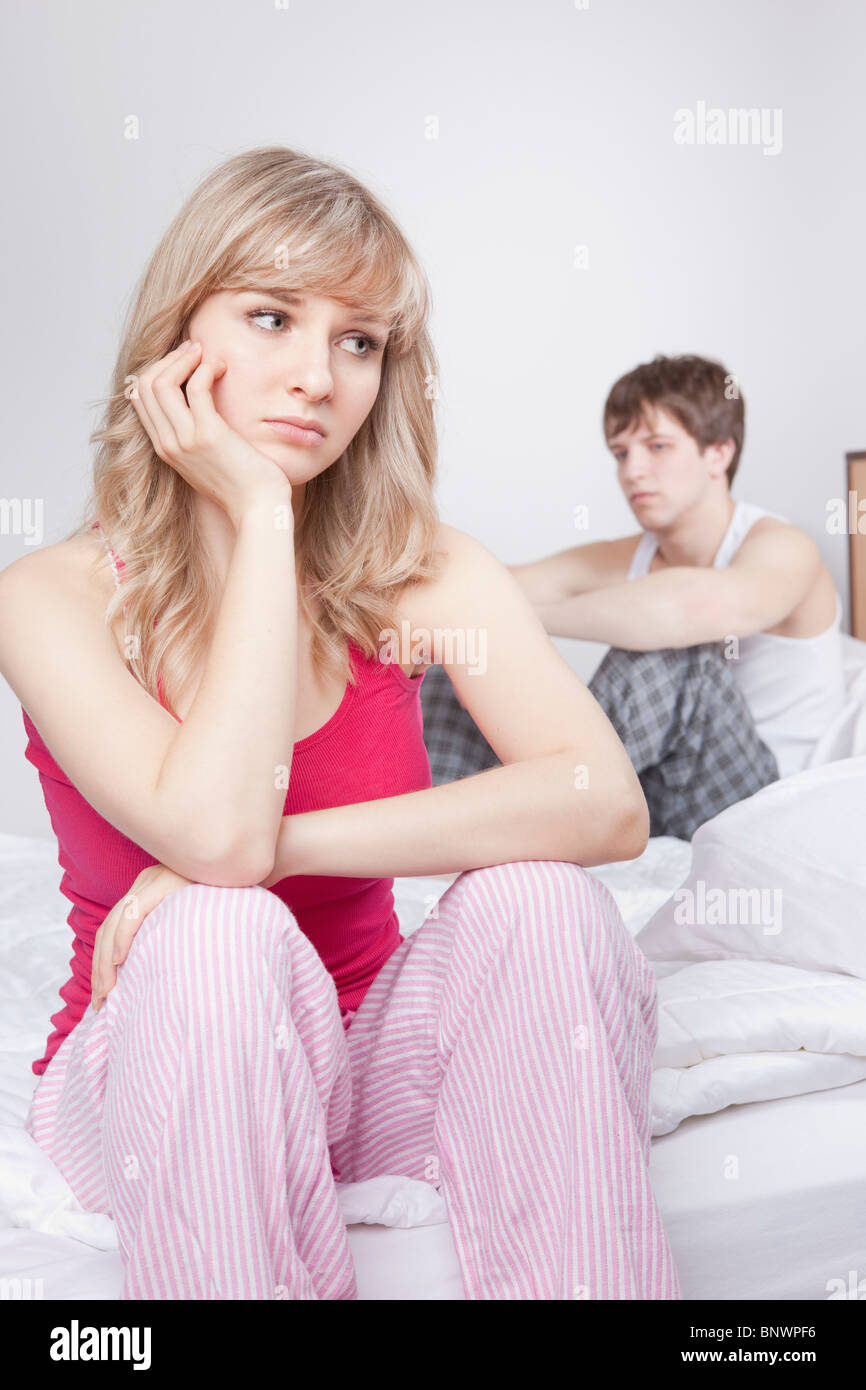 Couple sitting on bed after arguing Stock Photo