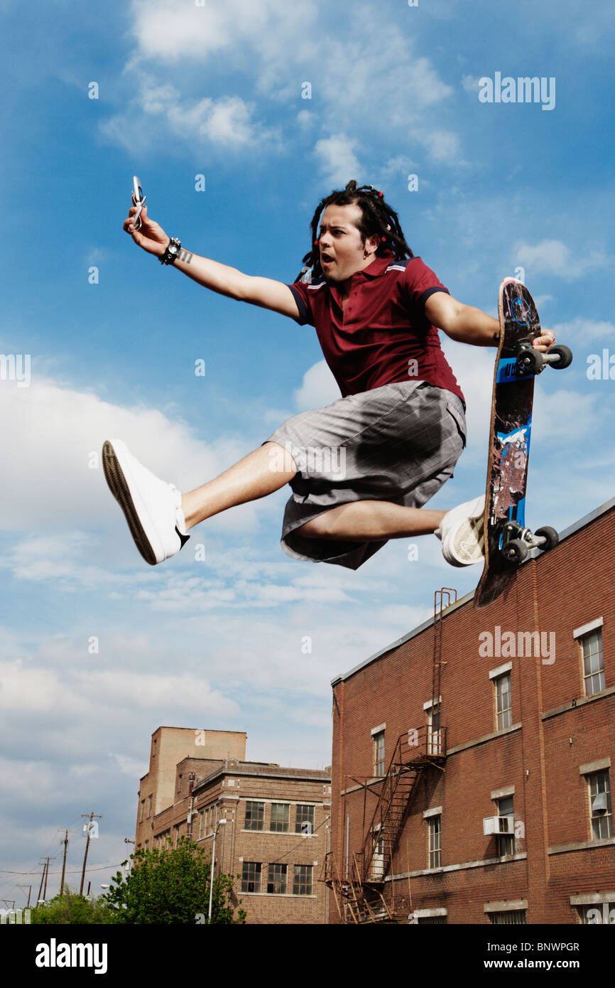 Teenage boy doing skateboard jump Stock Photo