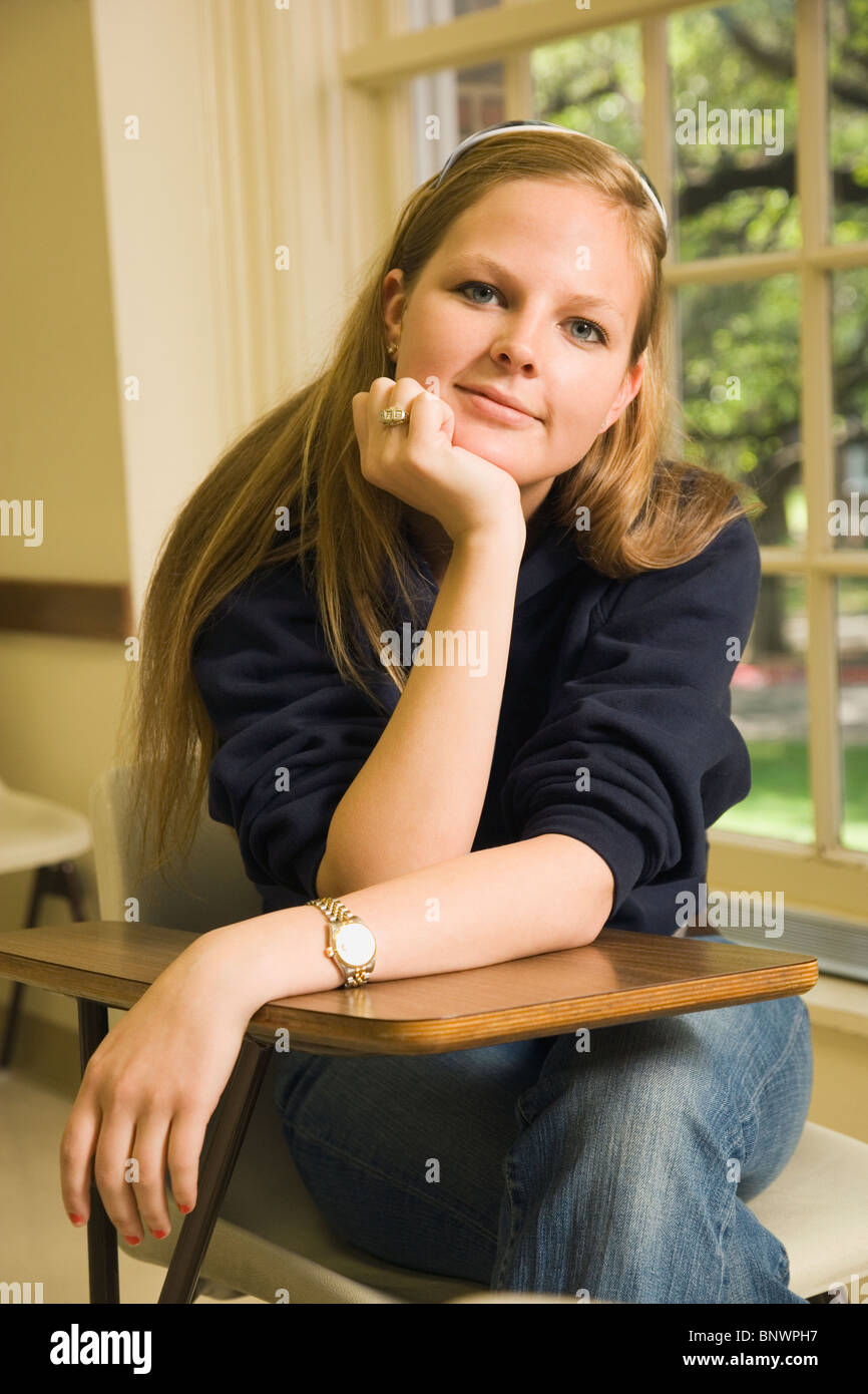 Teenage girl sitting at school desk Stock Photo - Alamy