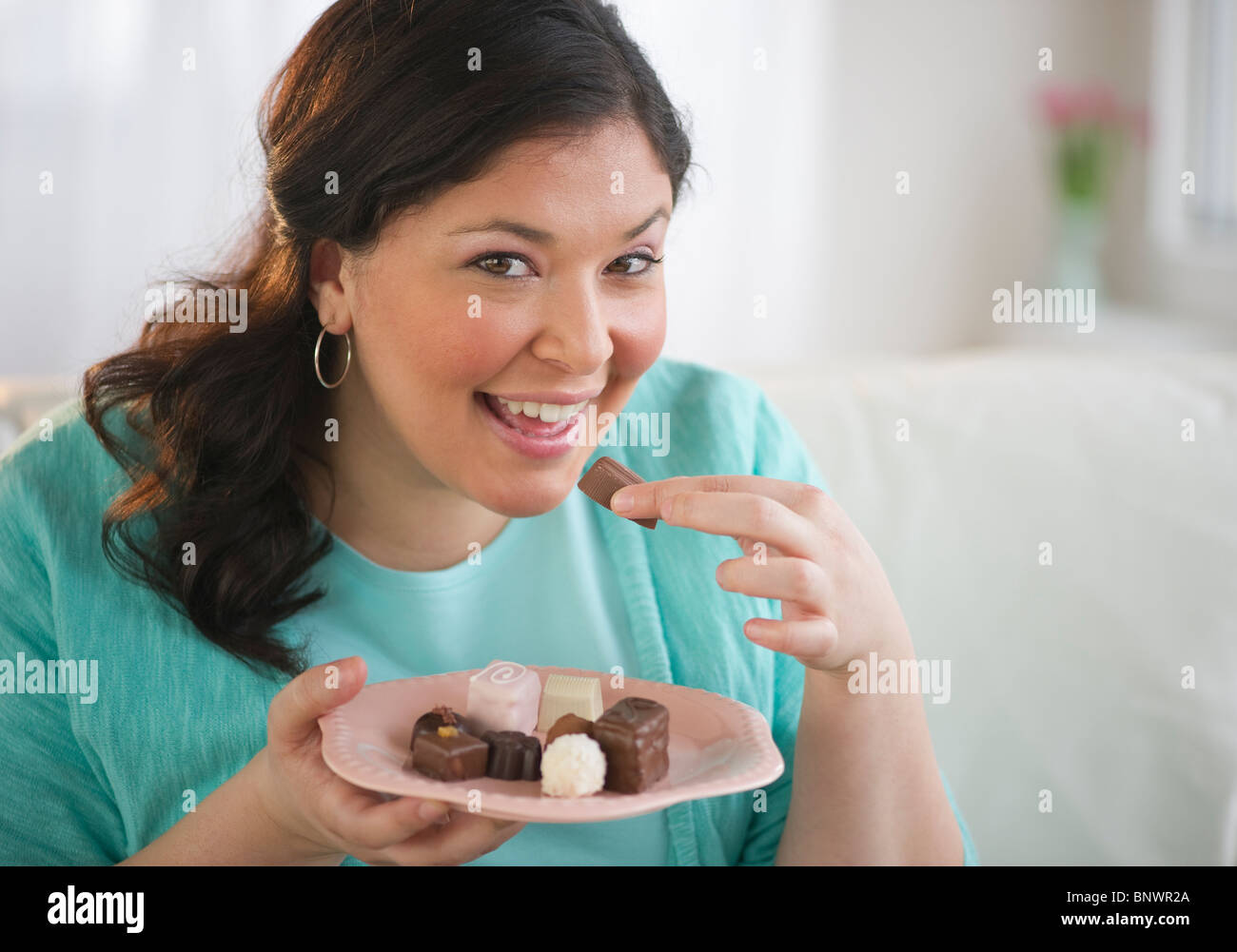 Woman eating chocolates Stock Photo