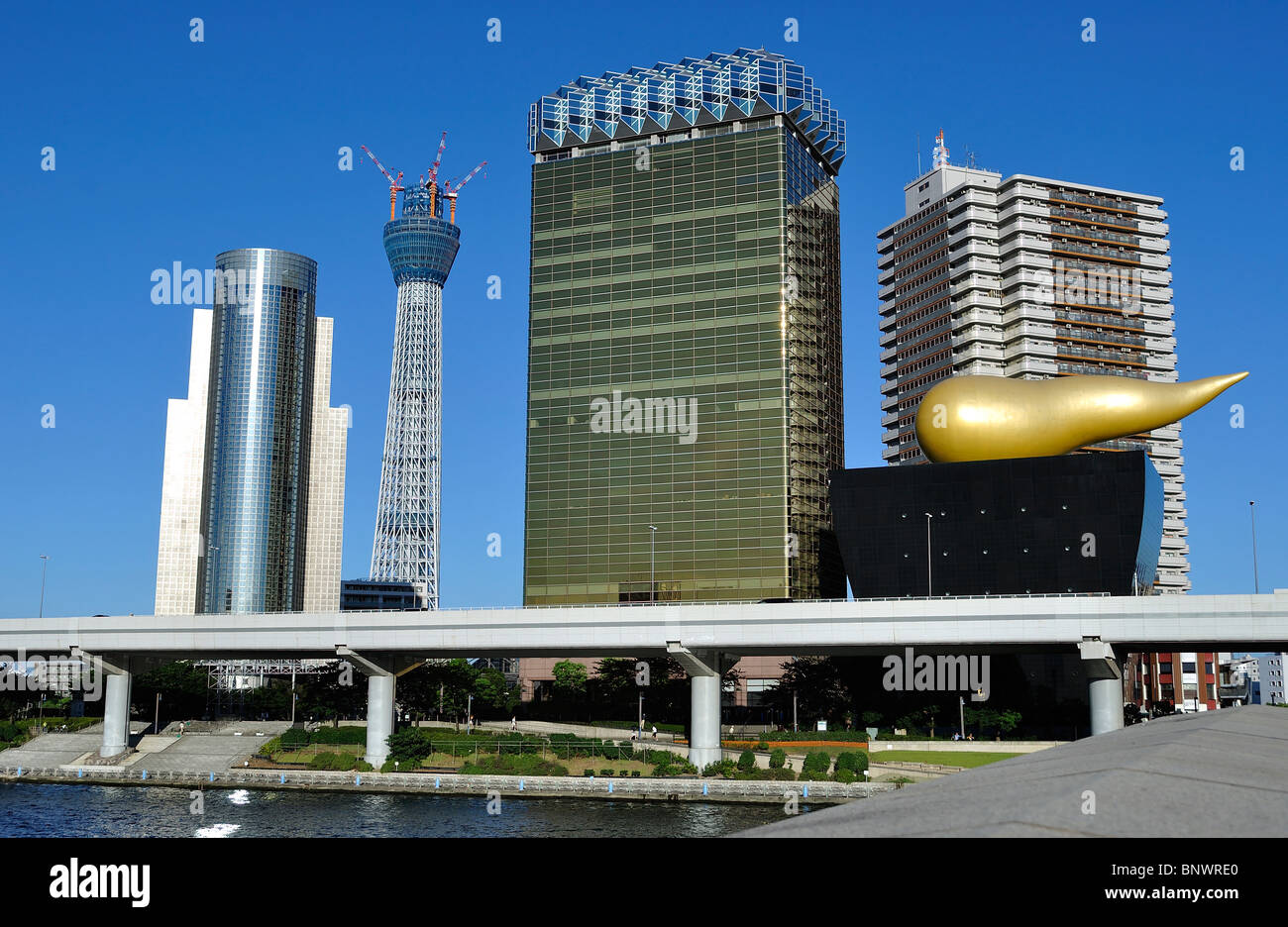 Asahi brewery complex next to the new 'Tokyo Sky Tree' TV tower under construction in Tokyo`s Asakusa area (Japan) Stock Photo