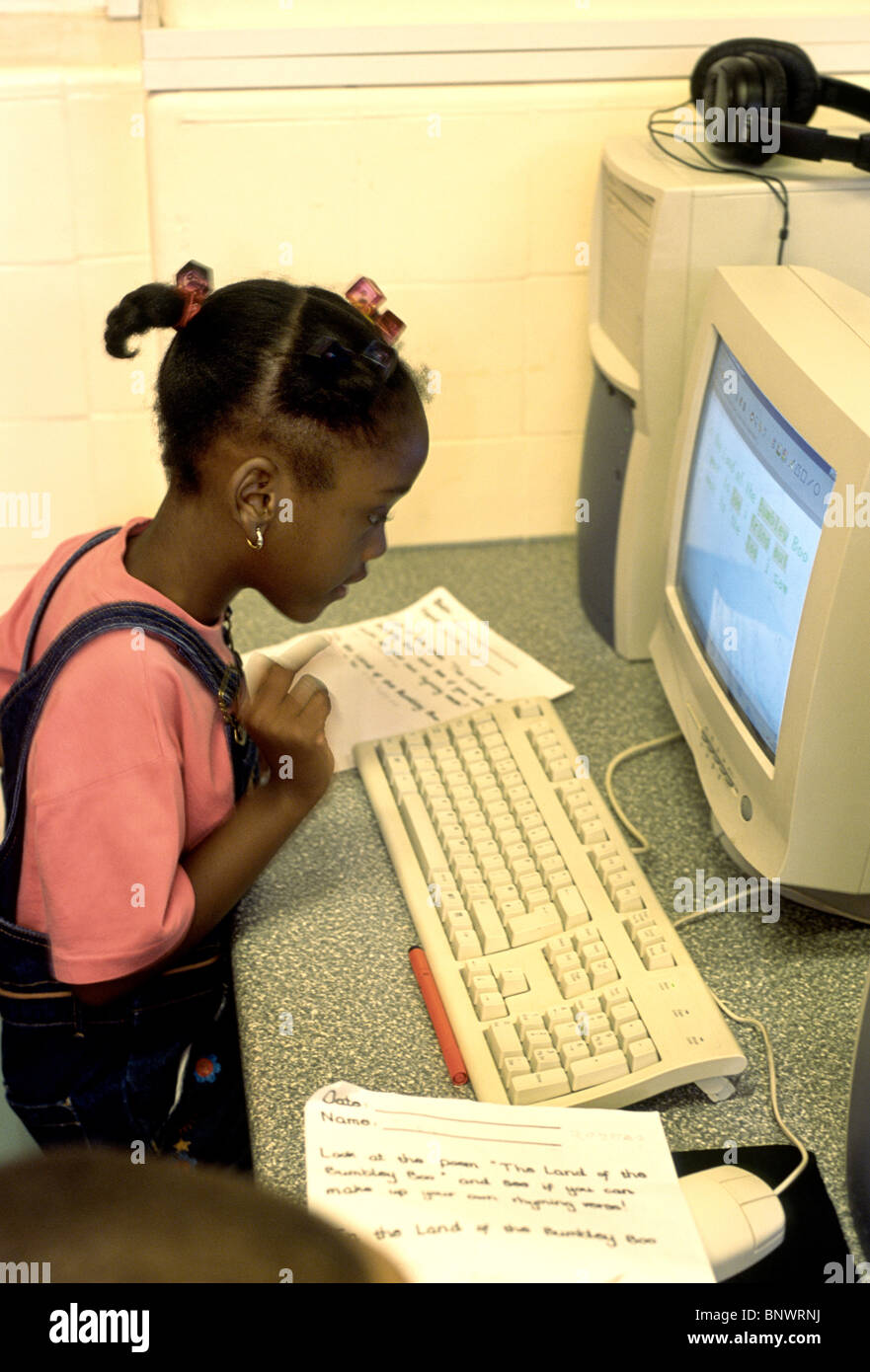 young girl in a classroom working on the computer Stock Photo - Alamy