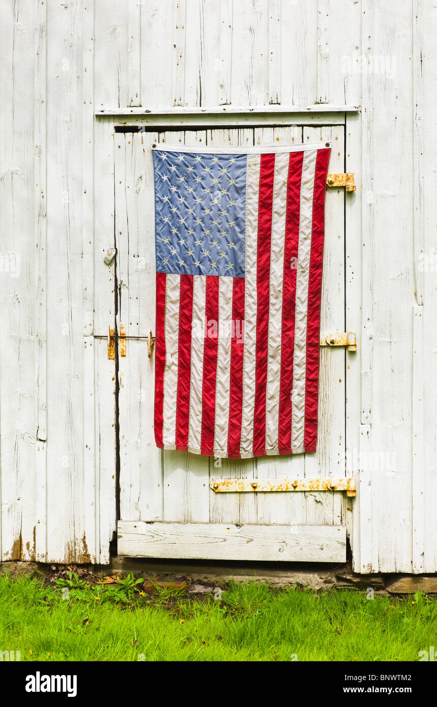 American flag draped on door of barn Stock Photo
